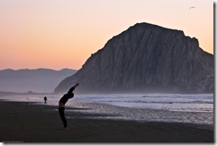Man performs stretching exercises on Morro Strand